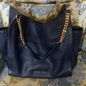 Michael Kors navy bag with gold chain.